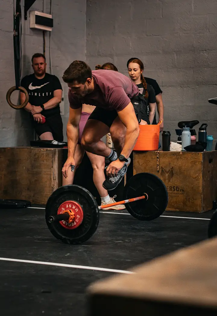 Athlete in a low squat with a barbell on her back