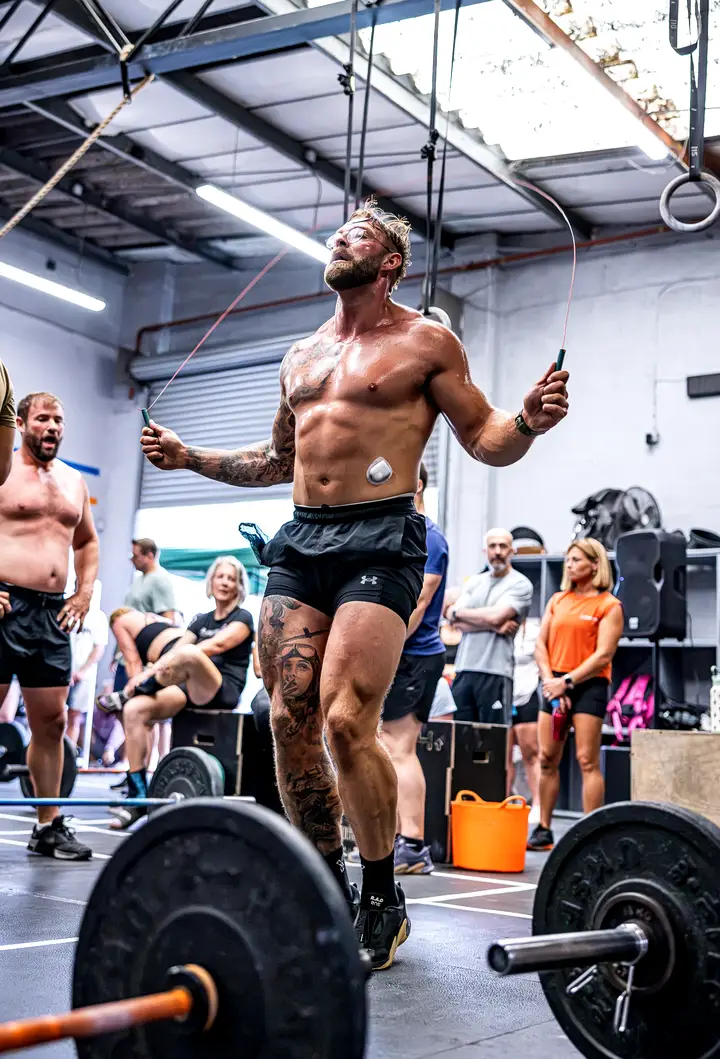 Athlete in a deep squat with a barbell across her shoulders