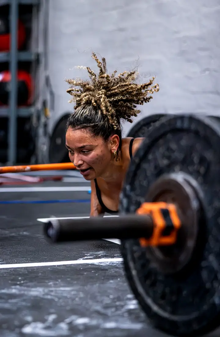 Woman in a deep squat with a barbell