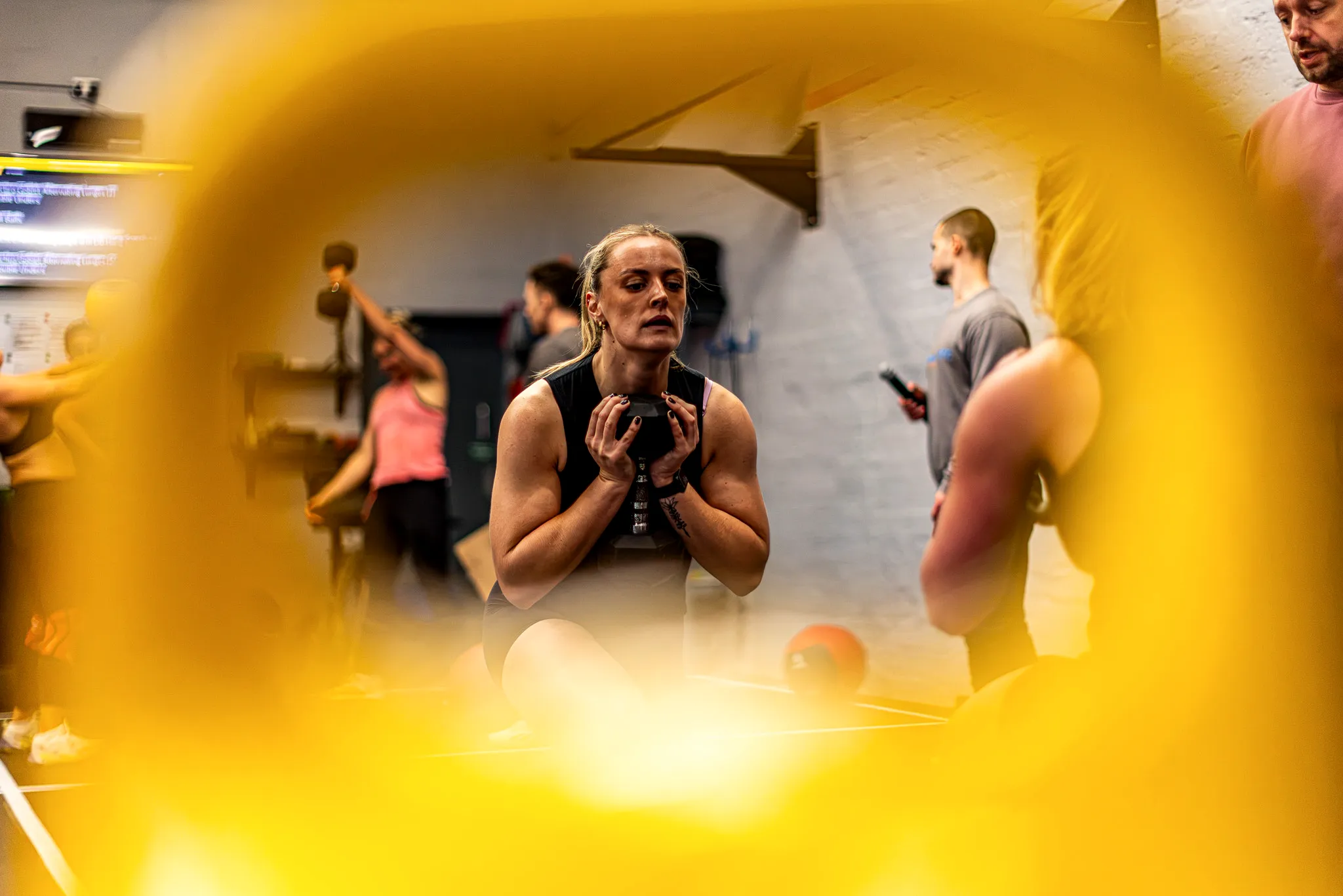 Athlete mid-air on a box jump, chalk dust in the air